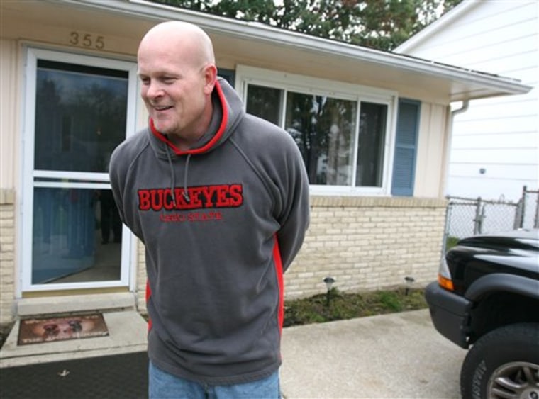 Joe Wurzelbacher, also known as "Joe The Plumber," laughs while chatting with the media outside of his home in Holland, Ohio, Oct. 16, 2008.